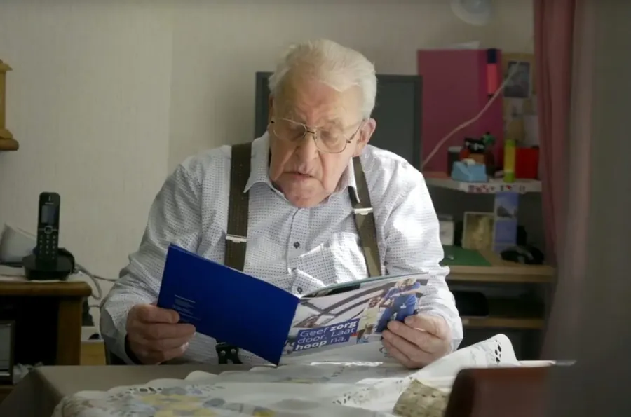 Mart Sissing leest de nalatenschapsbrochure van Mercy Ships.